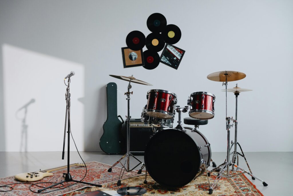 A modern music studio featuring drums, guitar, and vinyl records, includes essential requirements in a wedding musician's setup.
